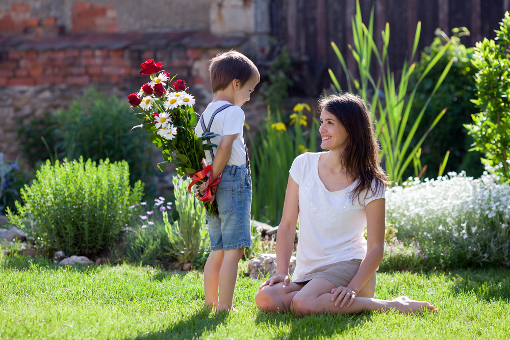 son giving flowers to mom