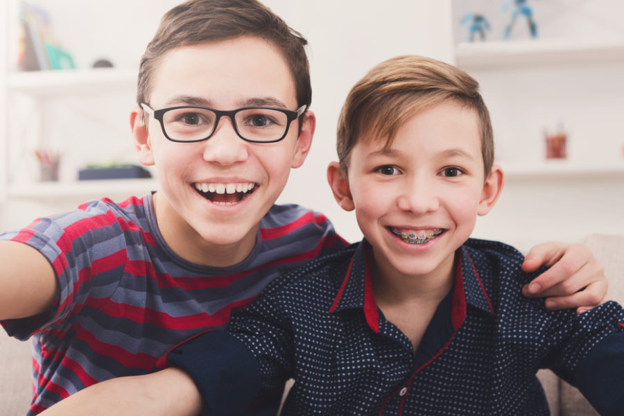 two-young-kids-smiling-with-braces-treatment