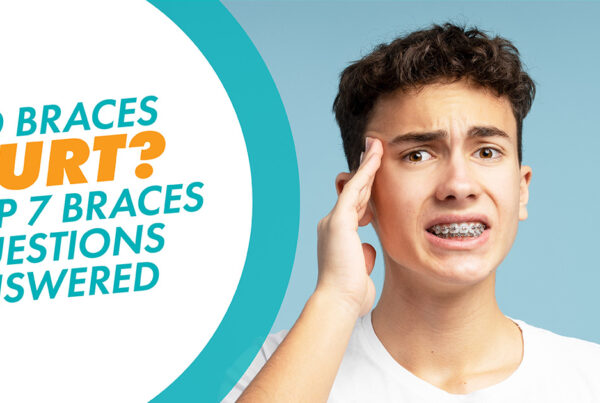 A teen with braces holding his head wondering why do braces hurt?